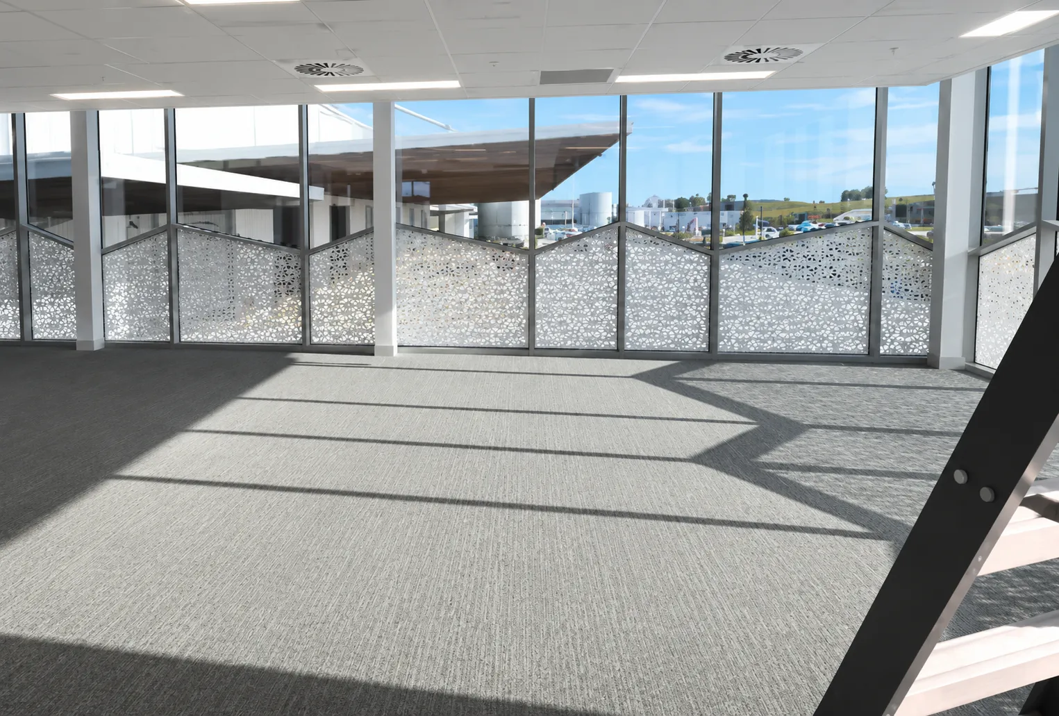 Full-height aluminium-framed glazing inside the upper-floor office of a Kemps Creek warehouse